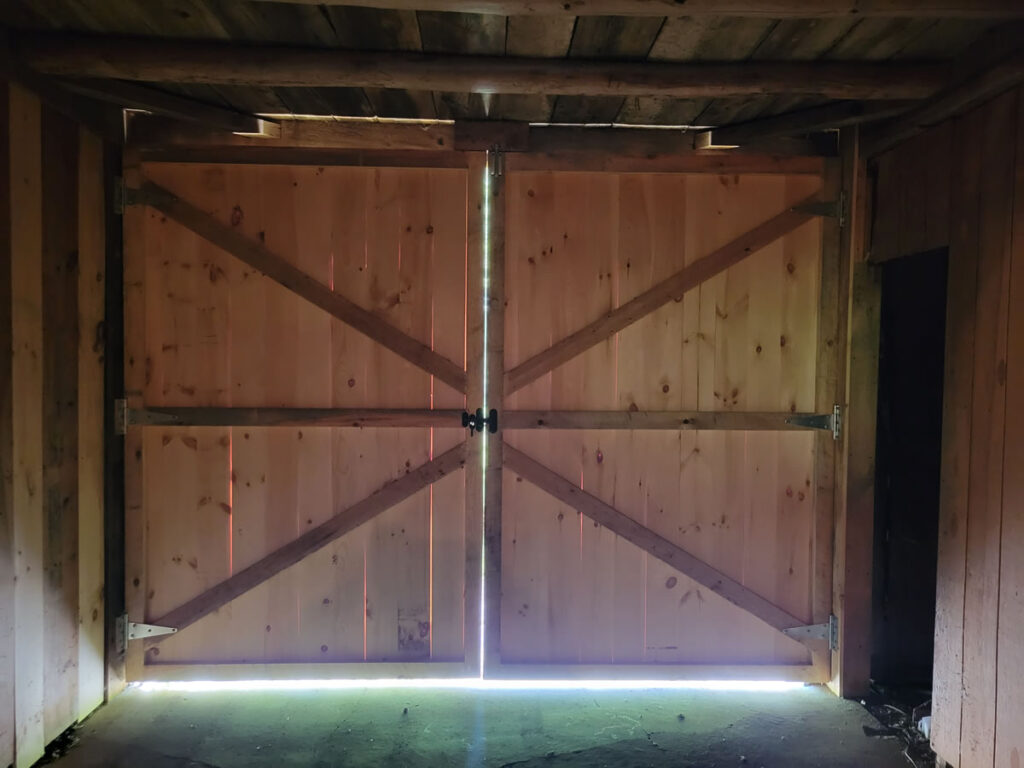 New swinging barn doors with hardware and top stop.